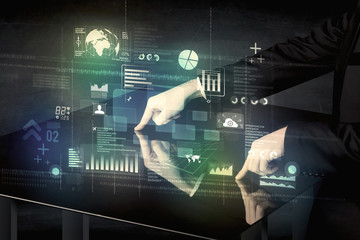 Businessman touching interactive modern desk with technology icons on table