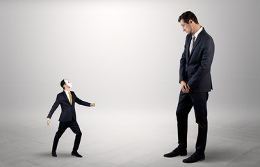 Fototapeta premium Conflict between small masked businessman and big elegant businessman 