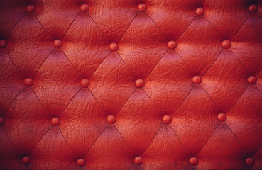 Texture of a red leather sofa as a background.