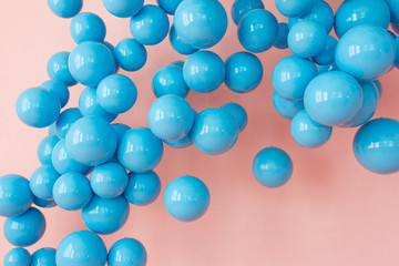 blue balloons, blue bubbles on pink background. Modern punchy pastel colors