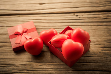 Red heart in  gift box on wooden plank. Concept for valentine day.