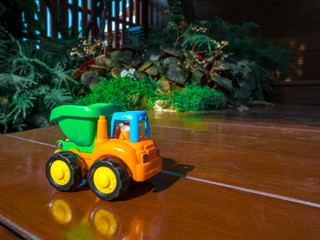 Small decorative toy track at the garden home. Macro abstract photo. Construction, mining, construction equipment at work holiday for baby