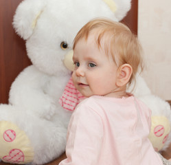 Portrait of a beautiful blonde child with toys