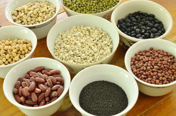 raw variety bean and cereal plant in cup on wooden table
