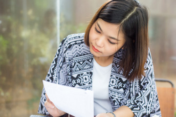 Asian beautiful women reading and writing business plan in cafe