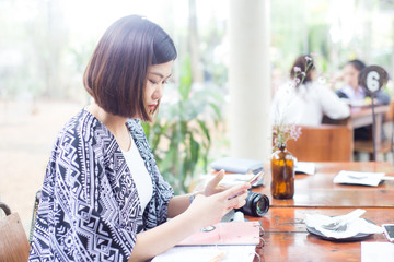 Asian beautiful women reading and writing business plan in cafe