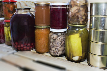 Storage shelves in pantry with homemade canned preserved fruits and vegetables