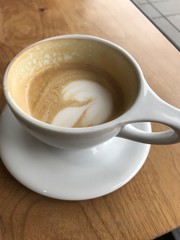 half empty cup of coffee  on a table in cafe at Portland Oregon USA