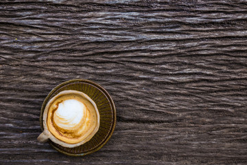 Hot latte art coffee texture on wood table
