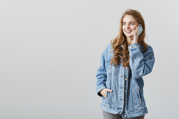 Looking from window and talking with boyfriend, dreaming to be near. Portrait of romantic...