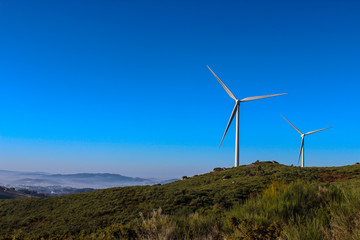 windmills in the mountains of Portugal produce energy with the help of wind