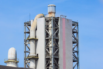 Refinery tower in petrochemical industrial plant with cloudy sky