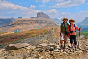 Happy family  travelling in Canadian Rockies. Active man and woman hikers  on trail. Dolomite Mountains in Banff National Park. Rocky Mountains.  Alberta. Canada.