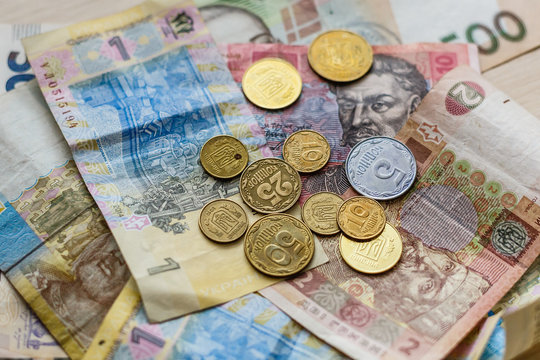 Pile of ukrainian coins on ukrainian banknotes background modern ukrainian money hryvnia