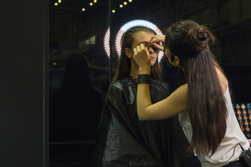 Stylist shows a master-class on professional make-up