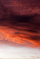 Dramatic sunset sky with evening sky clouds lit by bright sunlight