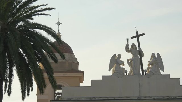 Statues and dome on a church rooftop