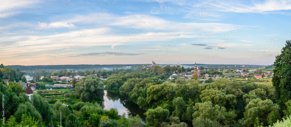 Wall mural evening panorama of russian city with a river and churches