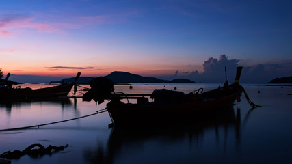 Longtail boat with coastal fishing village,Beautiful scenery view in morning sunrise over sea.