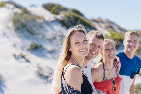 Attractive blond woman with friends at a beach