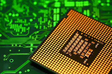 close up of computer cpu over green electronic circuit board