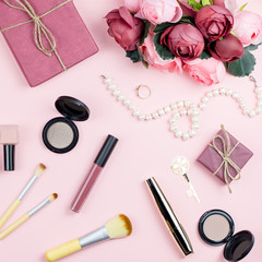 Obraz na płótnie Canvas Beauty blog concept flat lay. Fashion accessories, flowers, cosmetics, jewelry on pink background.