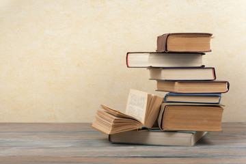 Stack of colorful books. Education background. Back to school. Book, hardback colorful books on wooden table. Education business concept. Copy space for text.