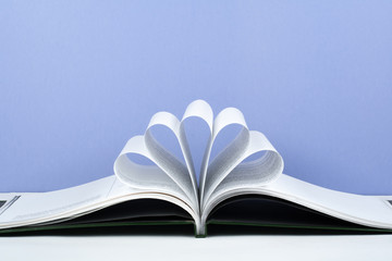 Old open hardback book, page decorate into a flower shape for love in Valentine's. love with open book heart.