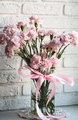 pink carnations on white windowsill