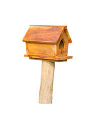 wooden bird house yellow on a pole isolated on a white background with clipping path.
