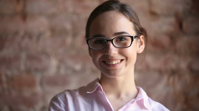 Young girl in glasses looking at camera, motivated student with big dreams studying abroad, ambitious smiling millennial posing indoors, creative happy manager starts successful career, optical shop