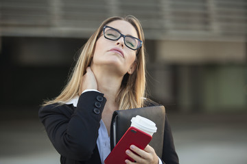 Portrait of stressed business woman with urban background