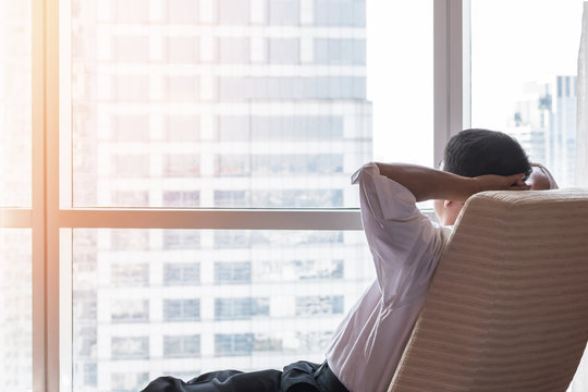 Life-work balance city living life style concept of business man relaxing, take it easy in office room resting with thoughtful mind thinking of lifestyle quality looking toward future vision