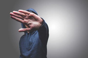 view of a man showing his hand hiding his face