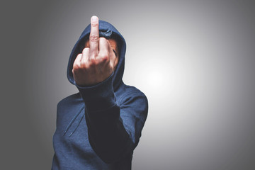 view of a man showing his middle finger hiding his face