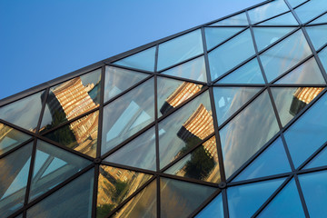 Multiple building reflections in architectural glass structure