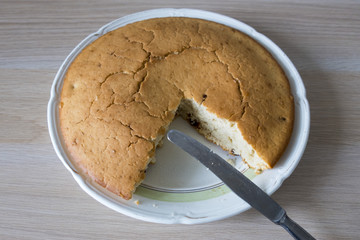 A beautiful and appetizing home-made cake closeup and a knife.