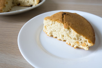 A nice and appetizing piece of homemade cake and a cupcake.
