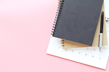 Business, office supplies, planning or meeting concept : Top view or flat lay of notebooks, calendar and pen on pink background, ready for adding or mock up