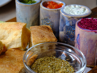 Close up of delicious lavash with different sauces and spices  on the wooden board . Pita bread	