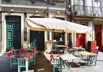 Empty terrace of a bar with sunbeds in a typical commercial of Flowers in the center of Porto (Portugal