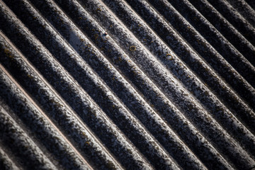 The texture of a voluminous slate on an old roof close up.