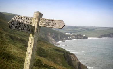 Public footpath waymarker signpost at Start Point in Cornwall England landscape