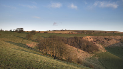 Obraz premium Stunning vibrant sunrise landscape image over English countryside landscape with lovely light hitting the hills