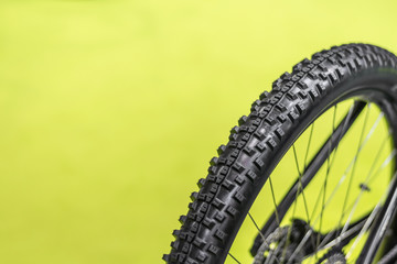 Moutain bike tire on green background. Bicycle component. Bicycle wheel. 