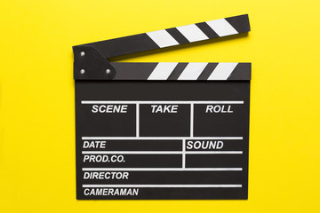 Fototapeta na wymiar movie clapper on yellow background; film, cinema and vedio photography concept