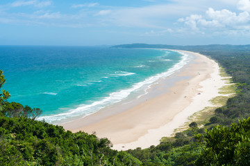 View over Tallow Beach with turquoise waters in Arakwai National Park at Byron Bay, NSW, Australia.