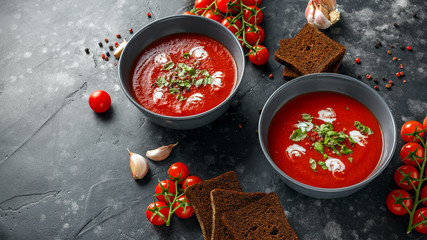 Tomato and fresh basil soup with garlic, cracked papper corns, served with cream and sourdough bread
