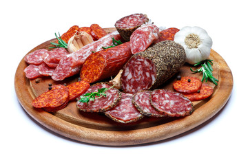 Various types of Dried organic salami sausage on wooden cutting board