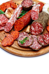Various types of Dried organic salami sausage on wooden cutting board